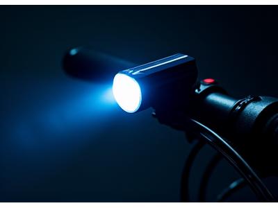 High-power front bicycle light illuminating a dark path